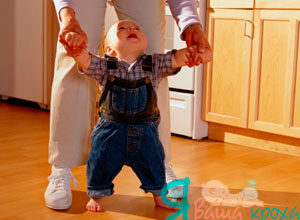 segure o bebê pelas mãos e caminhe com ele